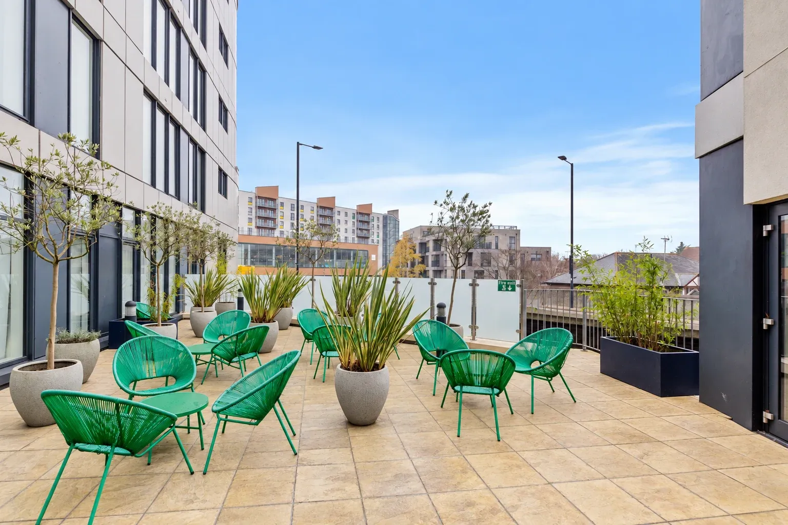 Outdoor terrace at Vonder Bradstowe with green seating and planters