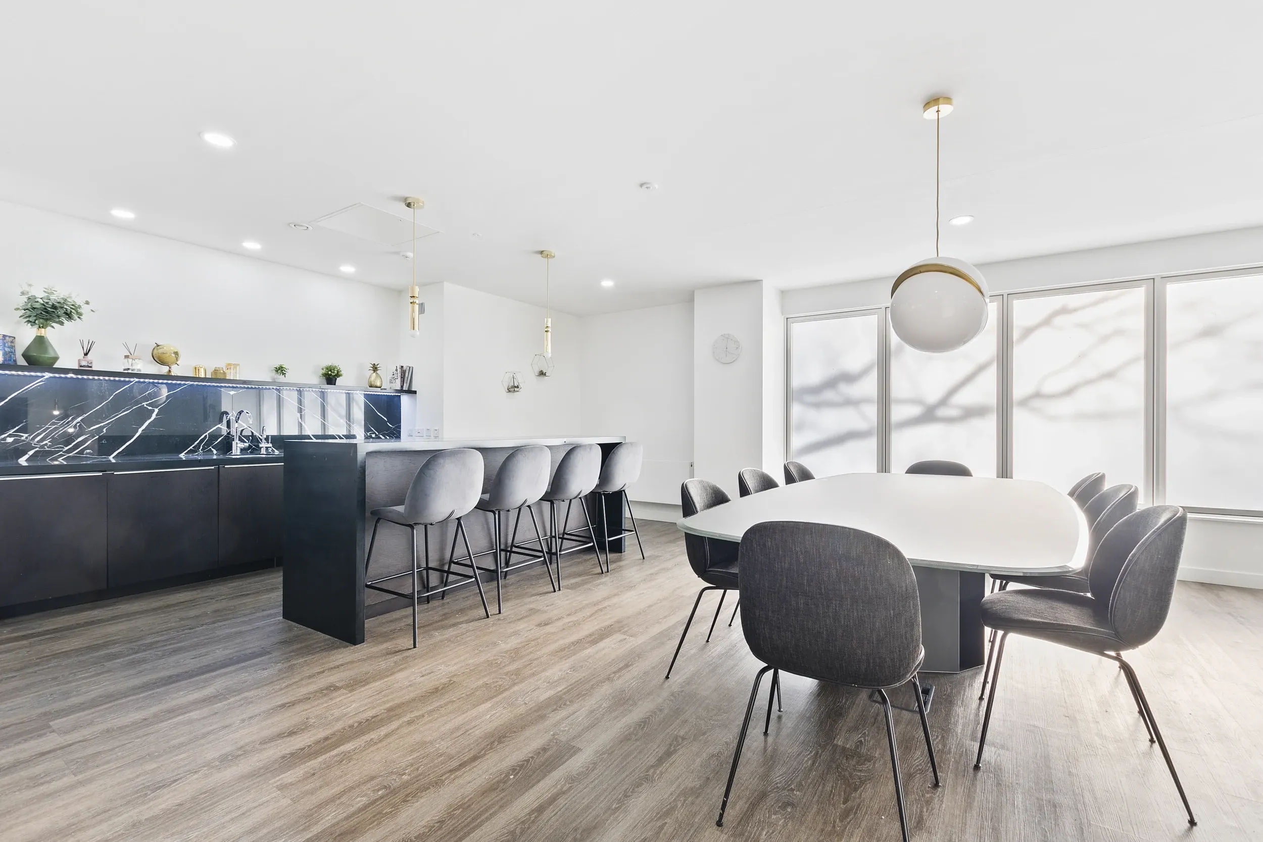 Residents' dining room at Vonder Crawley, with an oval table and bar seating at the counter