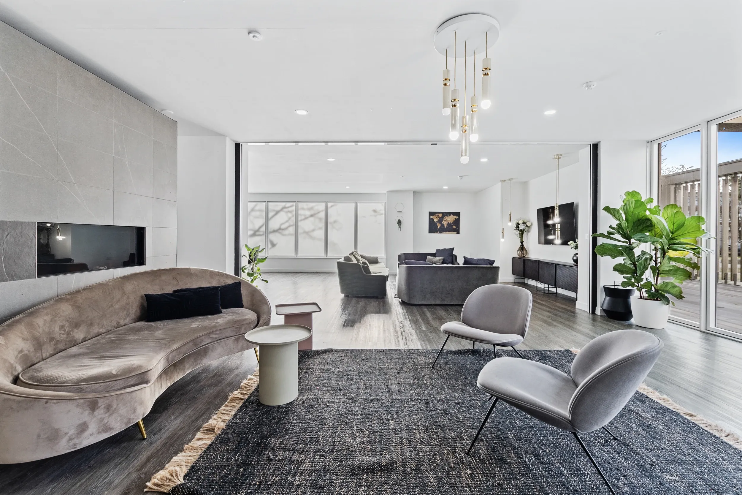 Lounge seating at Vonder Crawley, with a curved sofa, armchairs and a wall-mounted screen