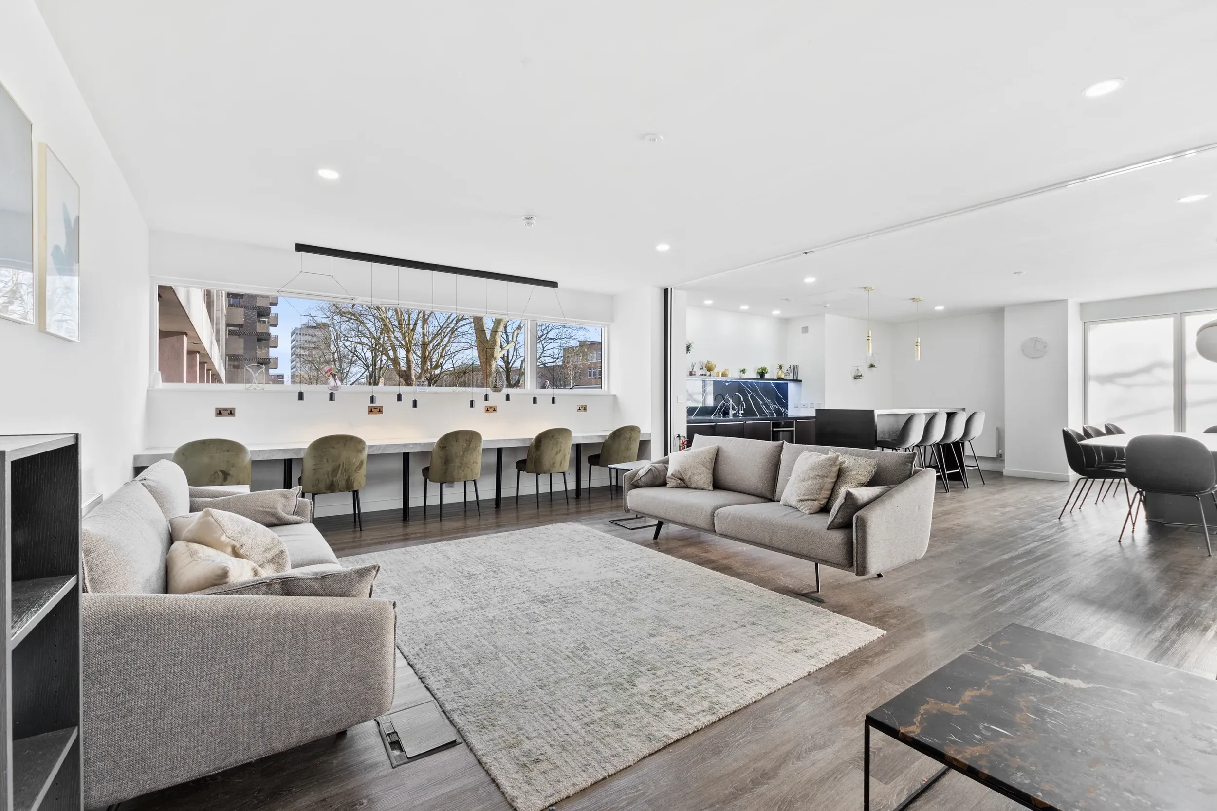 Residents' lounge at Vonder Crawley, with sofas, a long communal table and bar stools