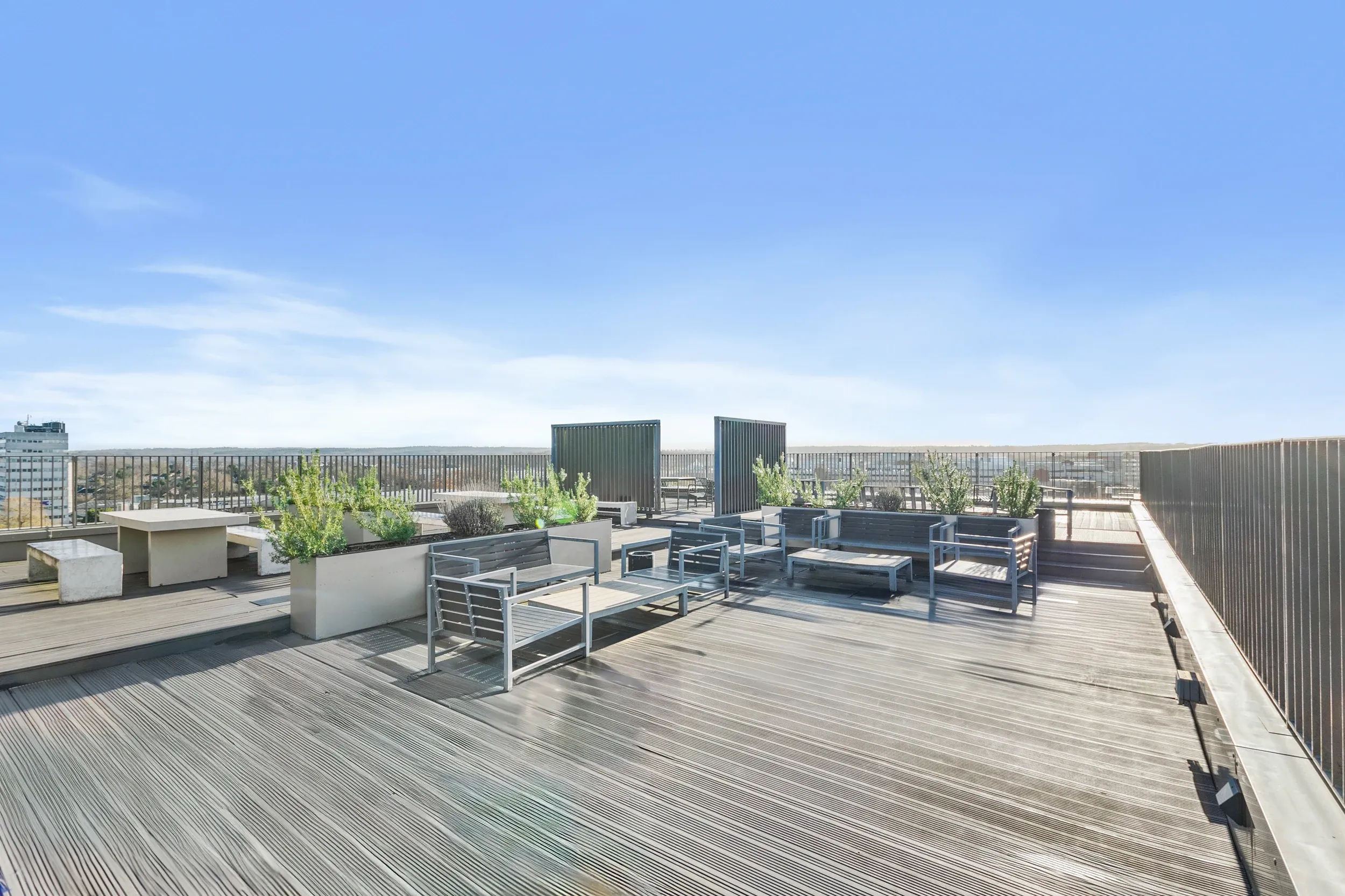 Roof terrace at Vonder Crawley, with decked seating, planters and views across the town