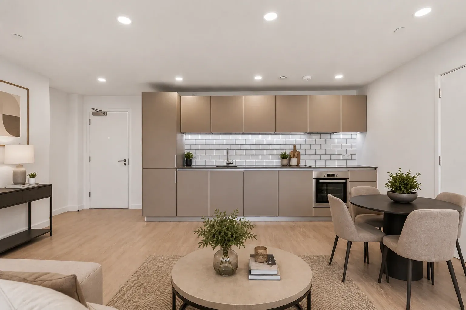 Open-plan living area and kitchen in a two-bedroom flat at Vonder Crawley, with a dining table for four