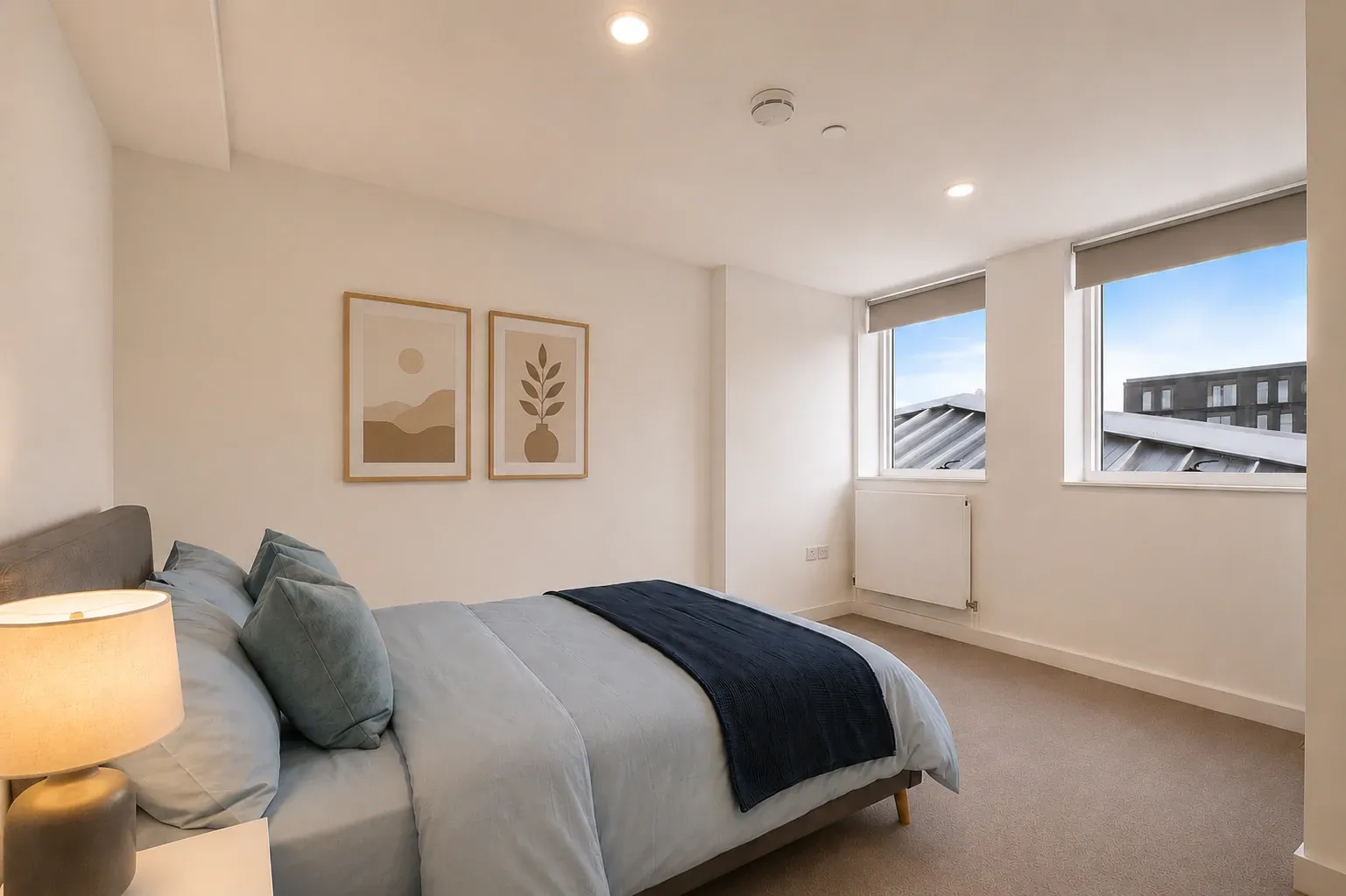 Double bedroom in a one-bedroom flat at Vonder Crawley, with a window and framed prints