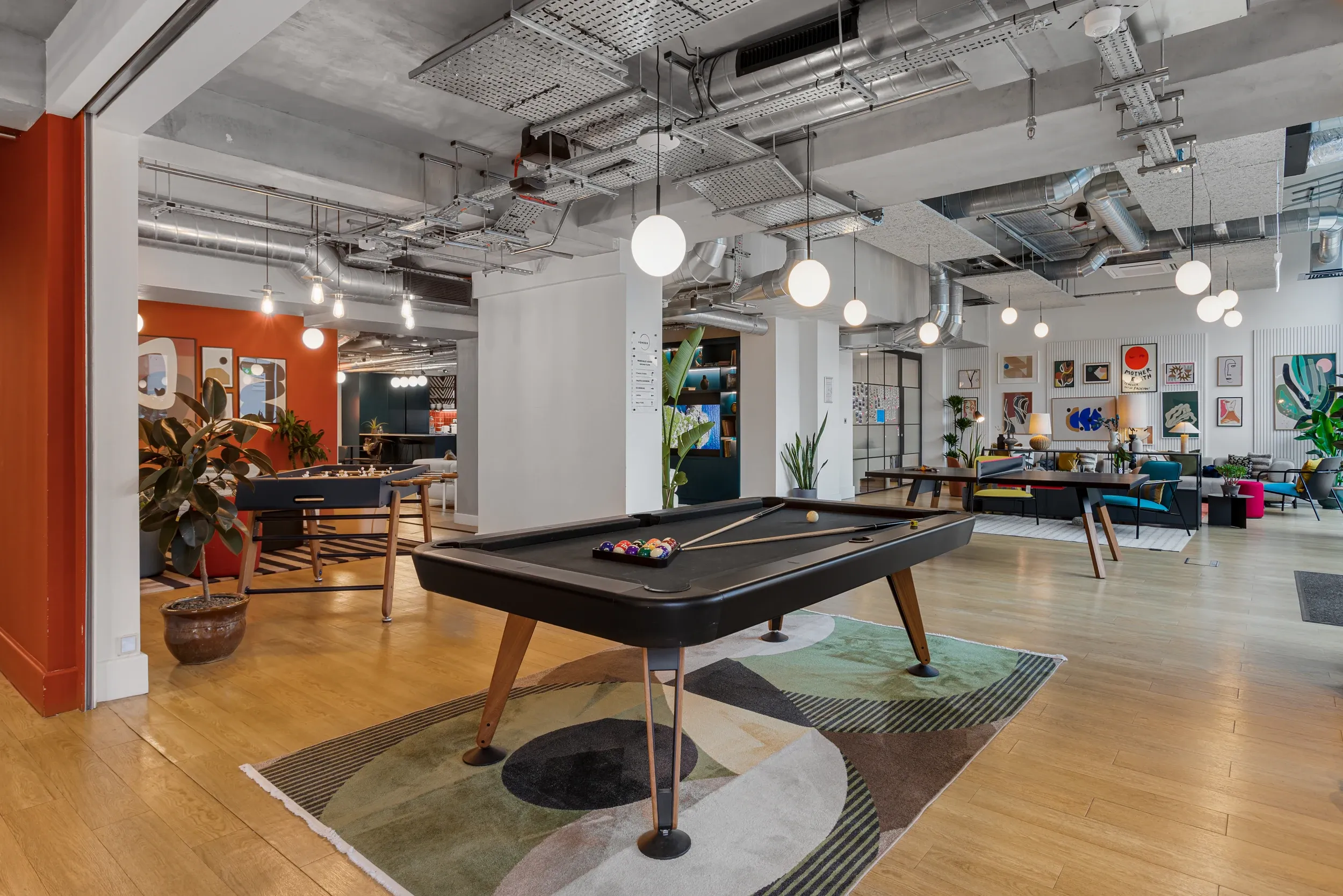 Games area at Vonder Wembley, with a pool table and colourful lounge seating