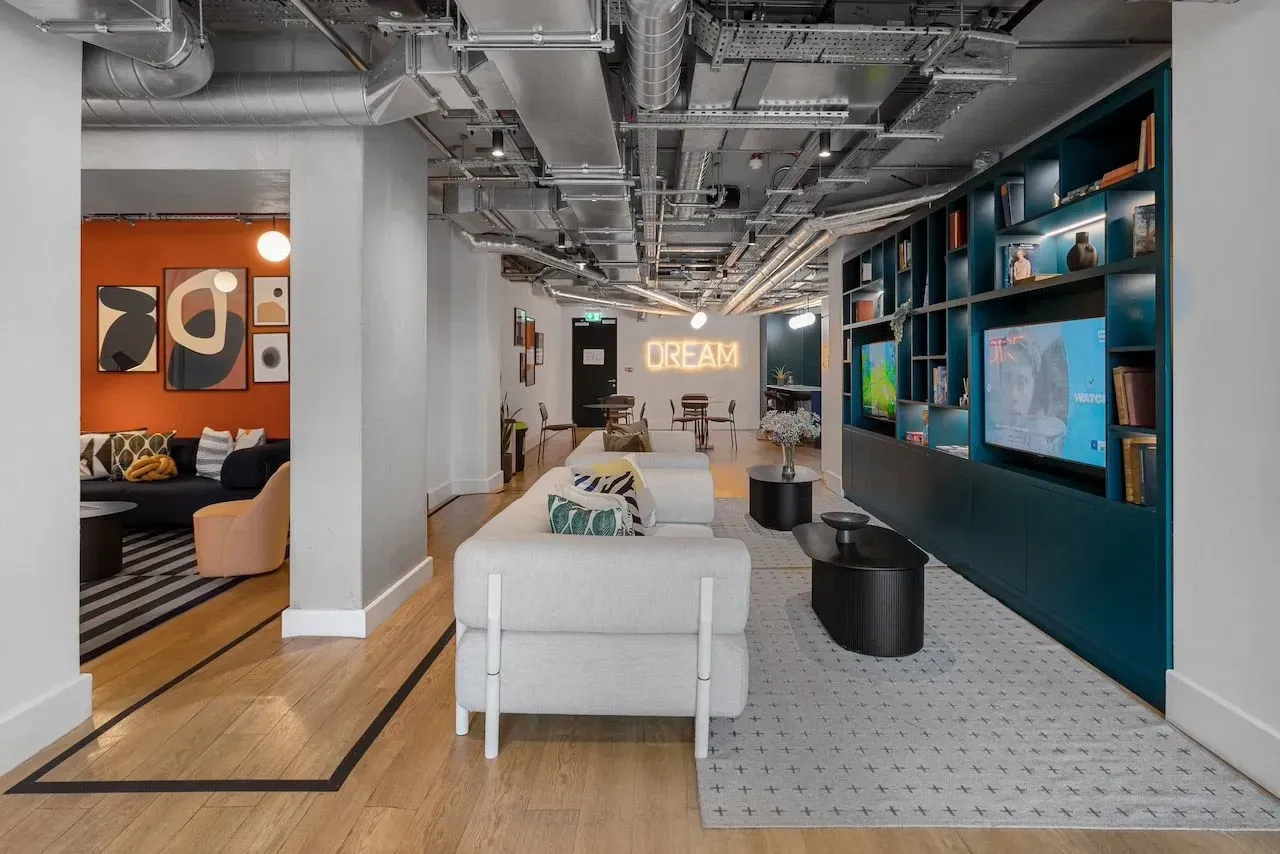 Gaming room at Vonder Wembley with wall-mounted screens and bench seating