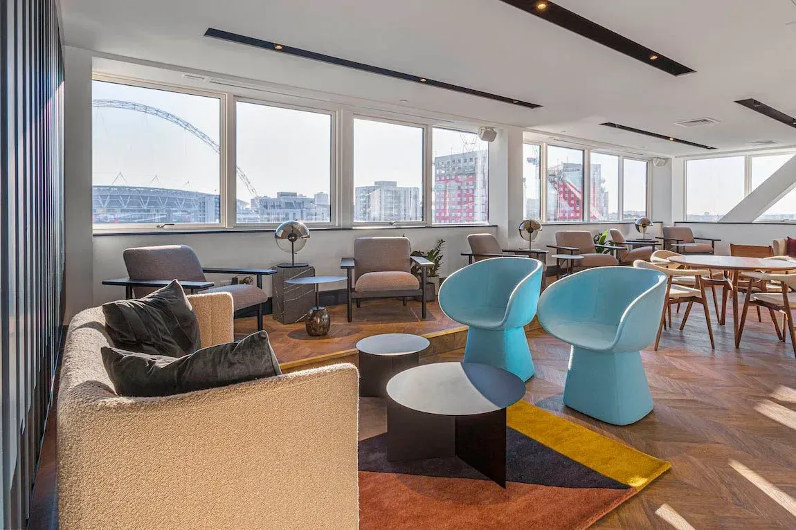 Residents' lounge at Vonder Wembley with armchairs and views towards Wembley Stadium