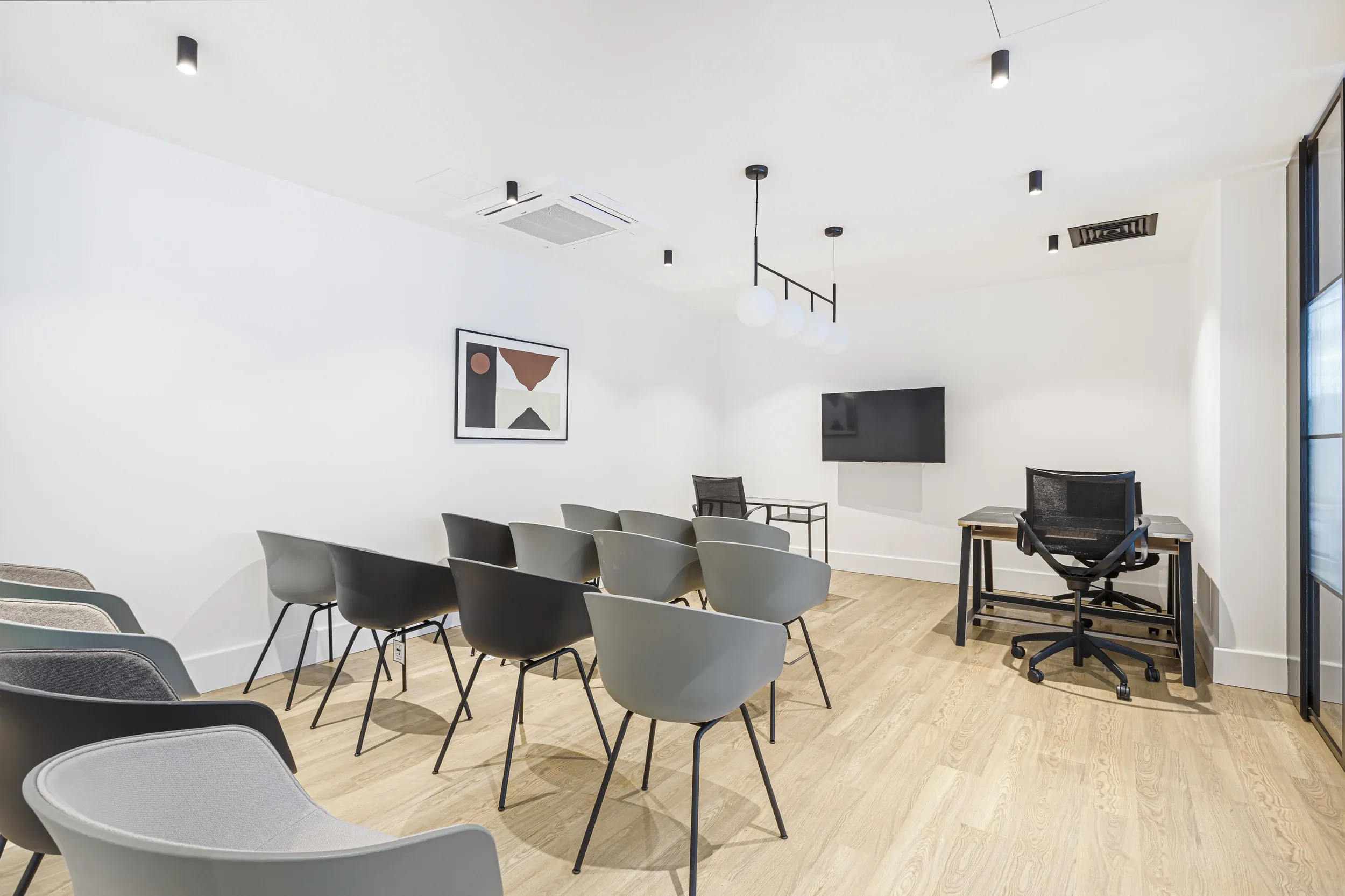 Meeting room at Vonder Wembley, set out with rows of chairs facing a wall-mounted screen