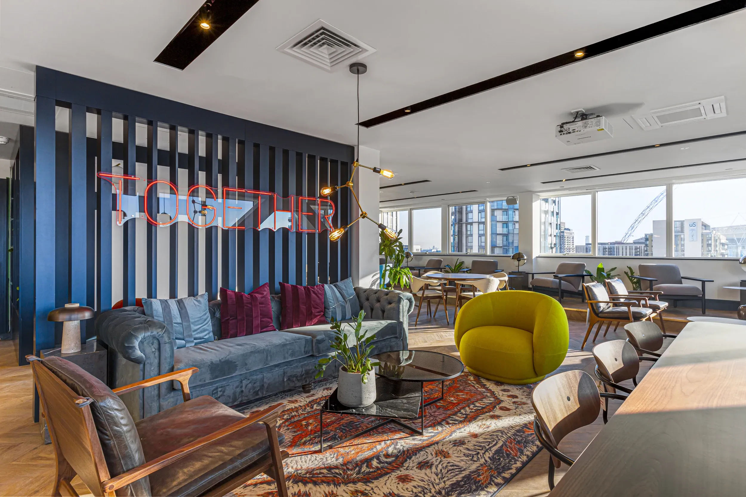 Seating area in the members' lounge at Vonder Wembley, with sofas, armchairs and rugs