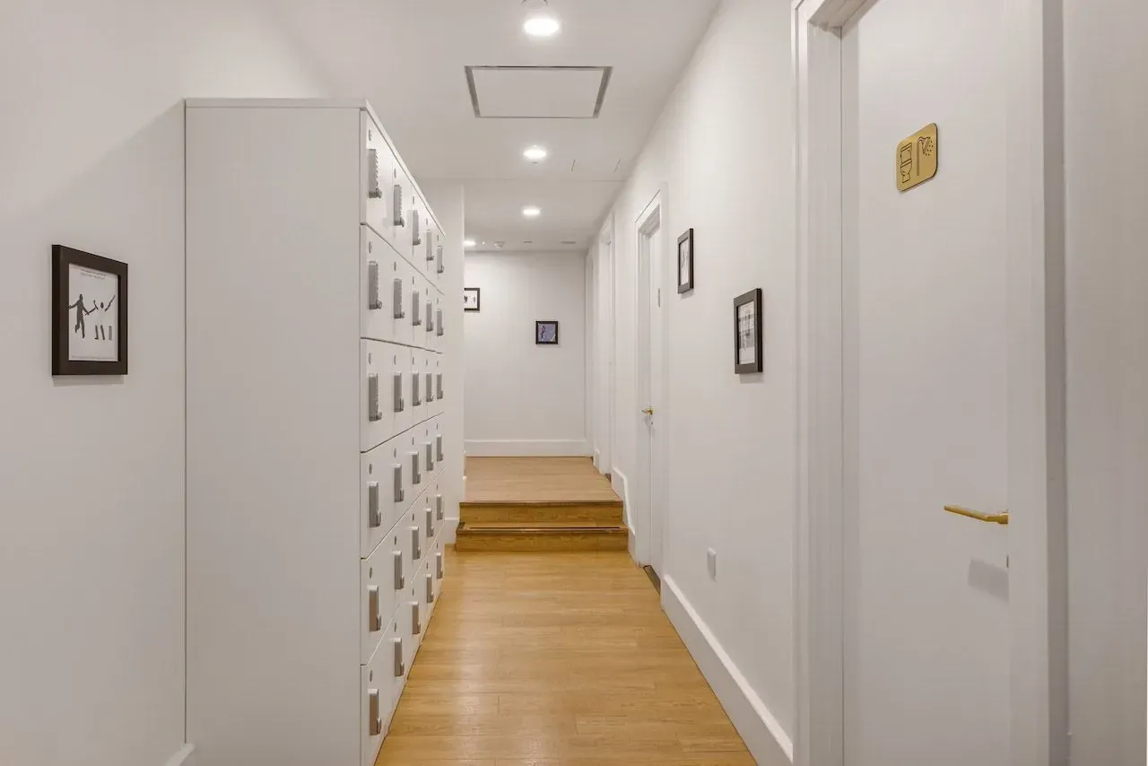 Residential corridor at Vonder Wembley with framed artwork between the flat entrances