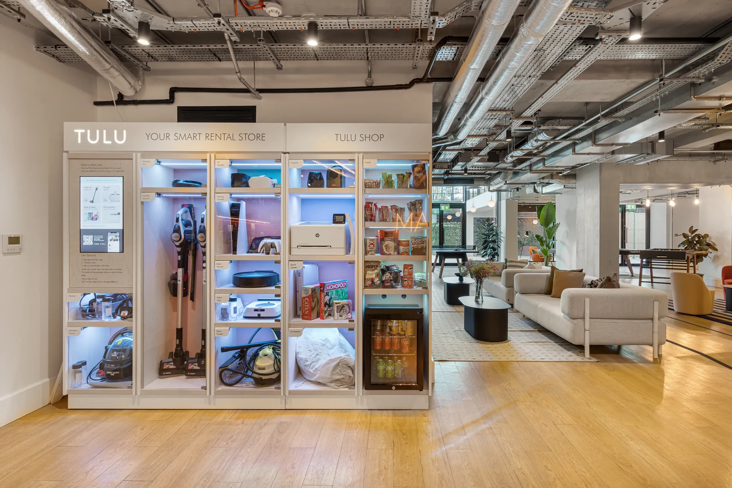 TULU smart rental station at Vonder Wembley, where residents borrow household items, with the lounge behind